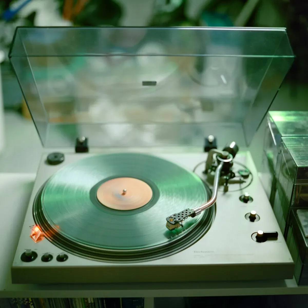 Coke bottle green vinyl spinning on a turntable, evoking the Tame Impala Currents aesthetic